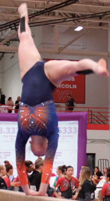 Keira Haser performs on beam.