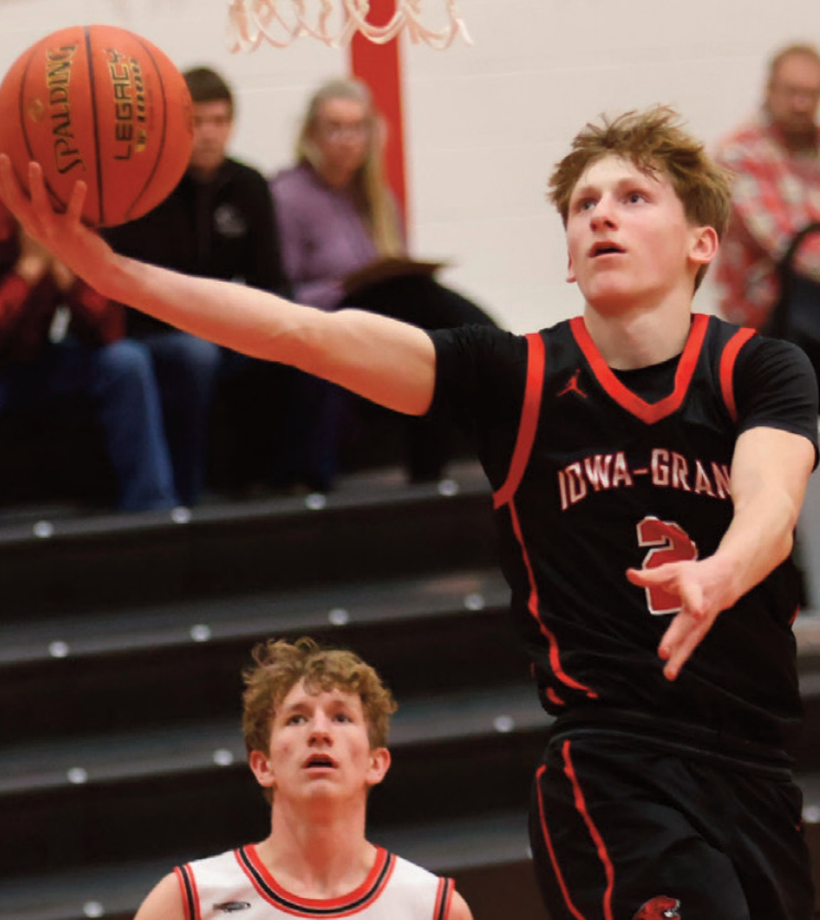 IG's Sam Lundell drives in for a basket. Photo by David Friesen.