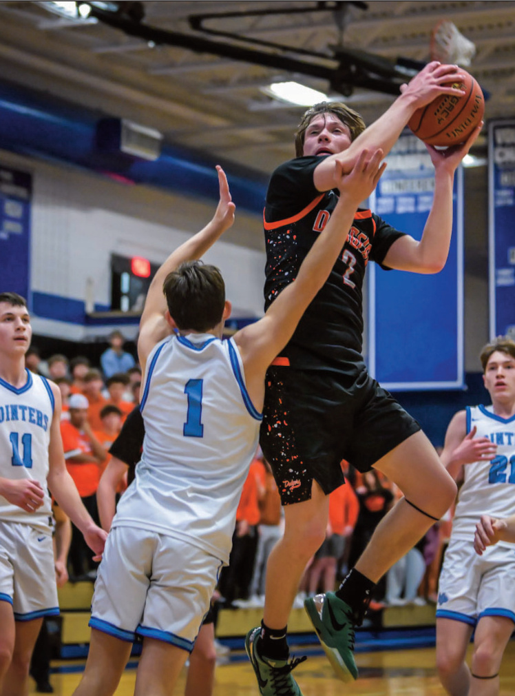 Dodger Bryce Crubaugh-Lockard drives on Pointer Thorin Vamstad with Drew Aschliman (11) and Keaton Dempsey (21) moving in. Bret Peterson photo.