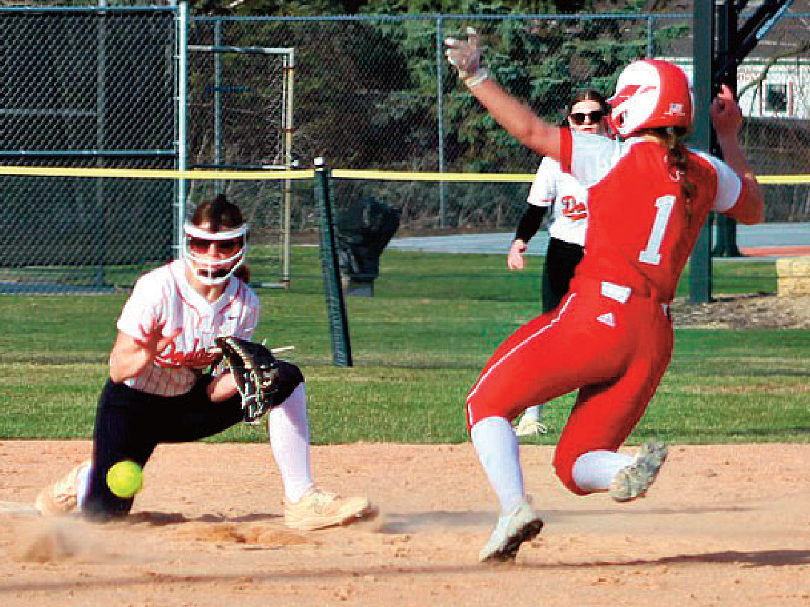 Dodger Breezy Wasley covers second base waiting for the ball as Cardinal runner Sumaryn Halverson tries to slide in. Photo by Angie Borne.