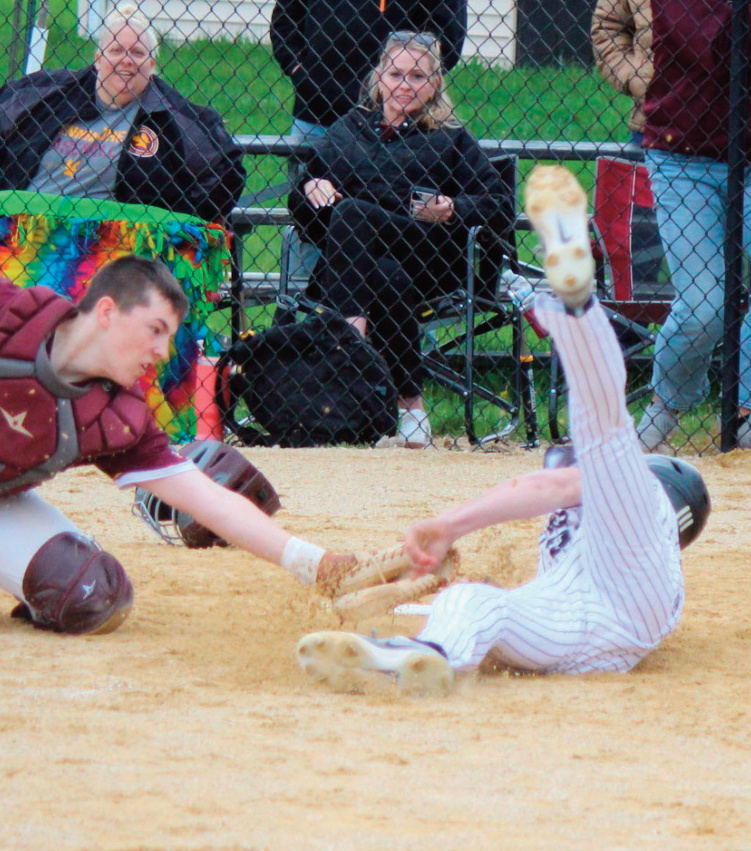 Panther Hayden Aultman is called safe at home on this close play at the plate against Fennimore.