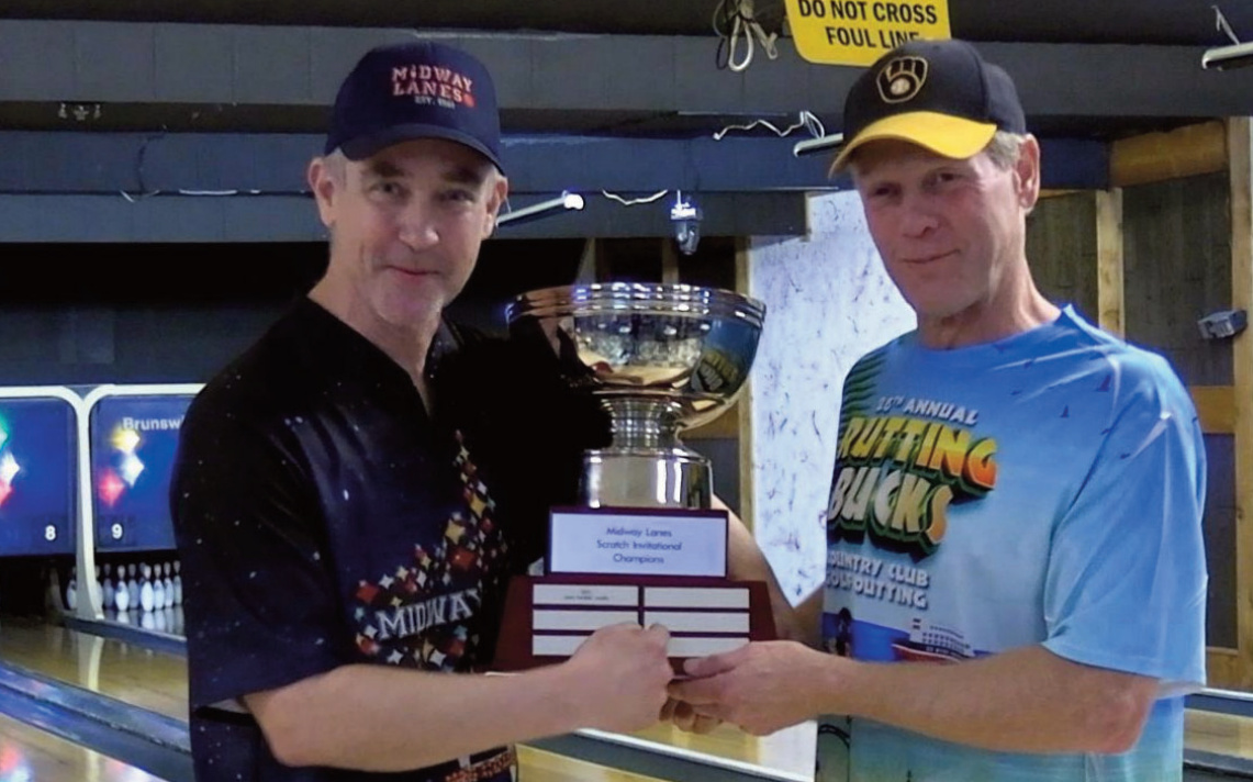 Last years Invitational champion Gary 'Horse' James (right) presents this years trophy to champion Kevin Gallagher who won this years scratch event.