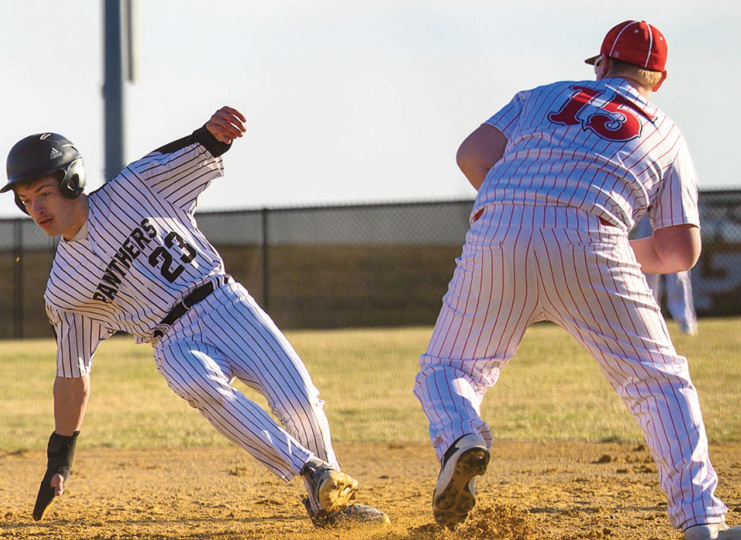 Panther Hayden Aultman dives back to first with Highland's Parker Brown cov- ering. Jonelle Degenhardt photo.