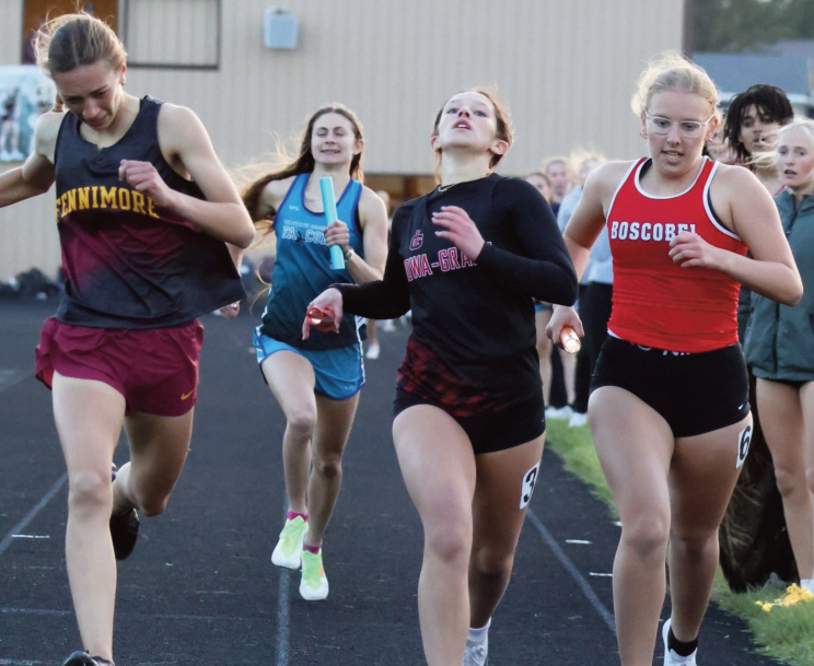 lowa-Grant's Trinity Loeffelholz is in a photo finish for 2nd in the 4x400 relay. Photo by David Friesen.