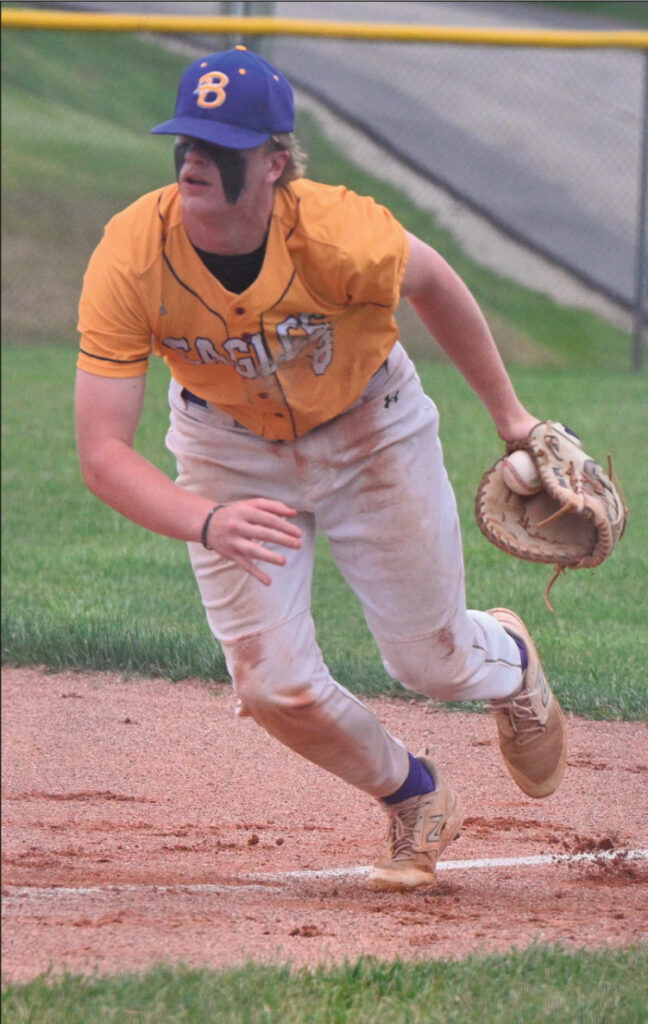 Adam Knight scoops up a grounder at first. Photo by Anita Schmid.