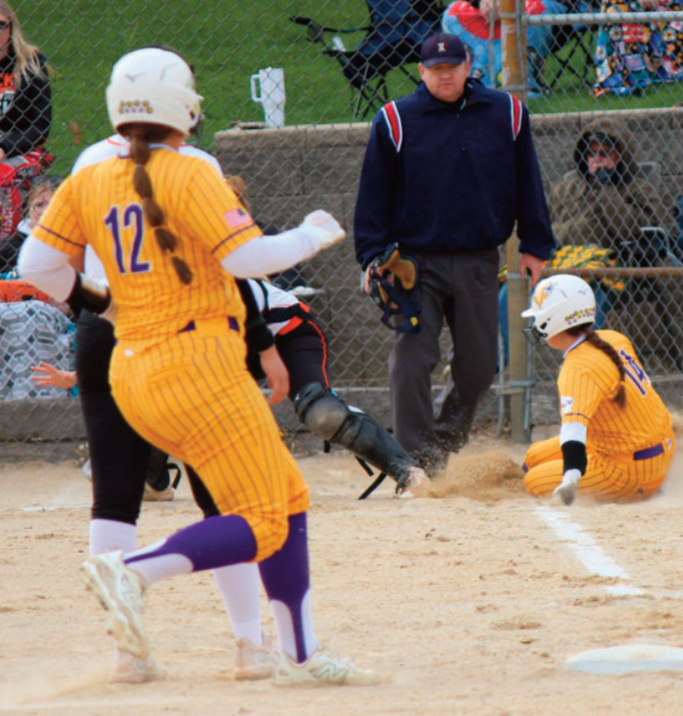 Eagles Addison Walker slides safely into home base as Mya Norton reaches third base against Belmont. Photo by John Dalton.