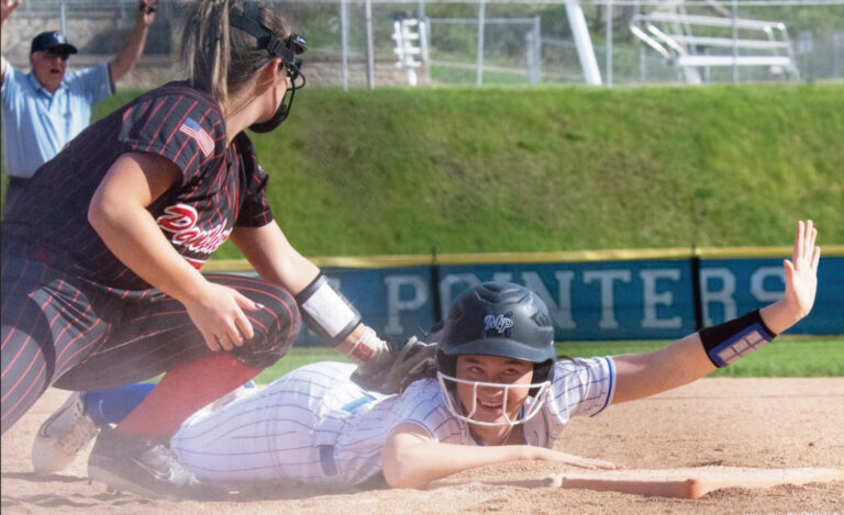 Pointer Kate James calls time out as she dives back into first safely with Panther Trinity Baker applying the tag. Photo by Cambrey Carey.