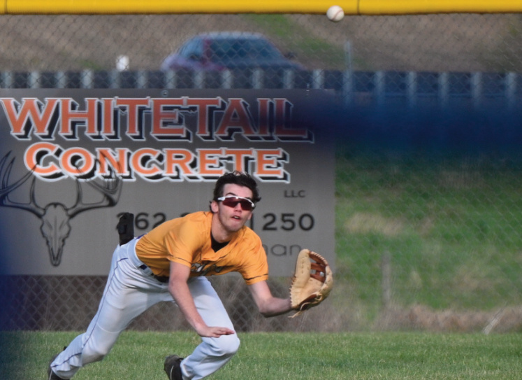 Cooper Shipman running for a fly ball and was able to make the diving catch for the out. Photo by Anita Schmid.