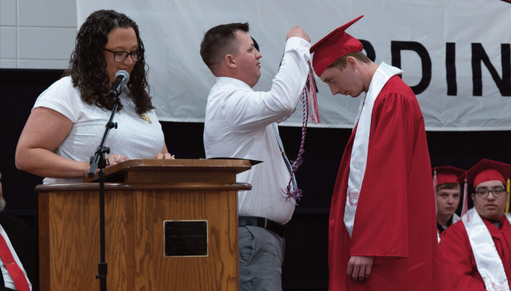 Ben Ford receiving Highland's first ever, red, white and blue cord at podium