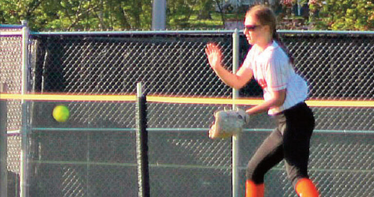 Kendra Brom fields a ball in the outfield. Photo by Angie Borne.