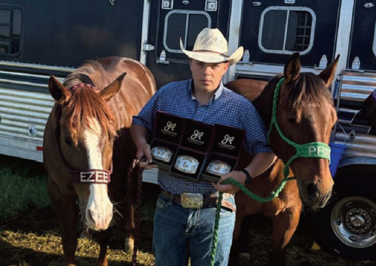 Lance Miller standing with horses