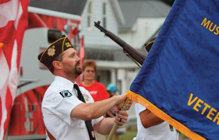 Matt Aide carrying a veterans flag