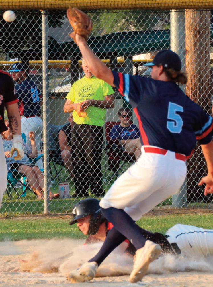 Grant Roh slides into home plate.