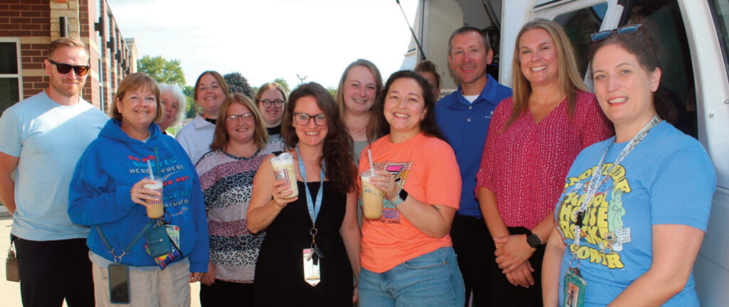 Teachers standing with coffee