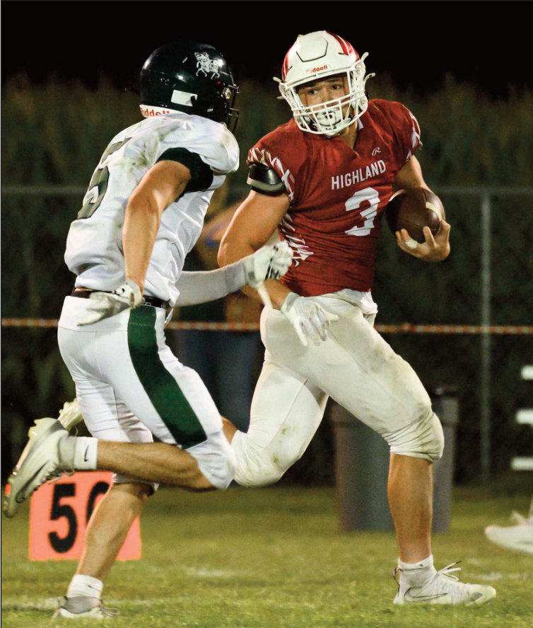 Cardinal senior Tanner Degenhardt tries to elude a Heights tackler. Photo by Jonelle Degenhardt.