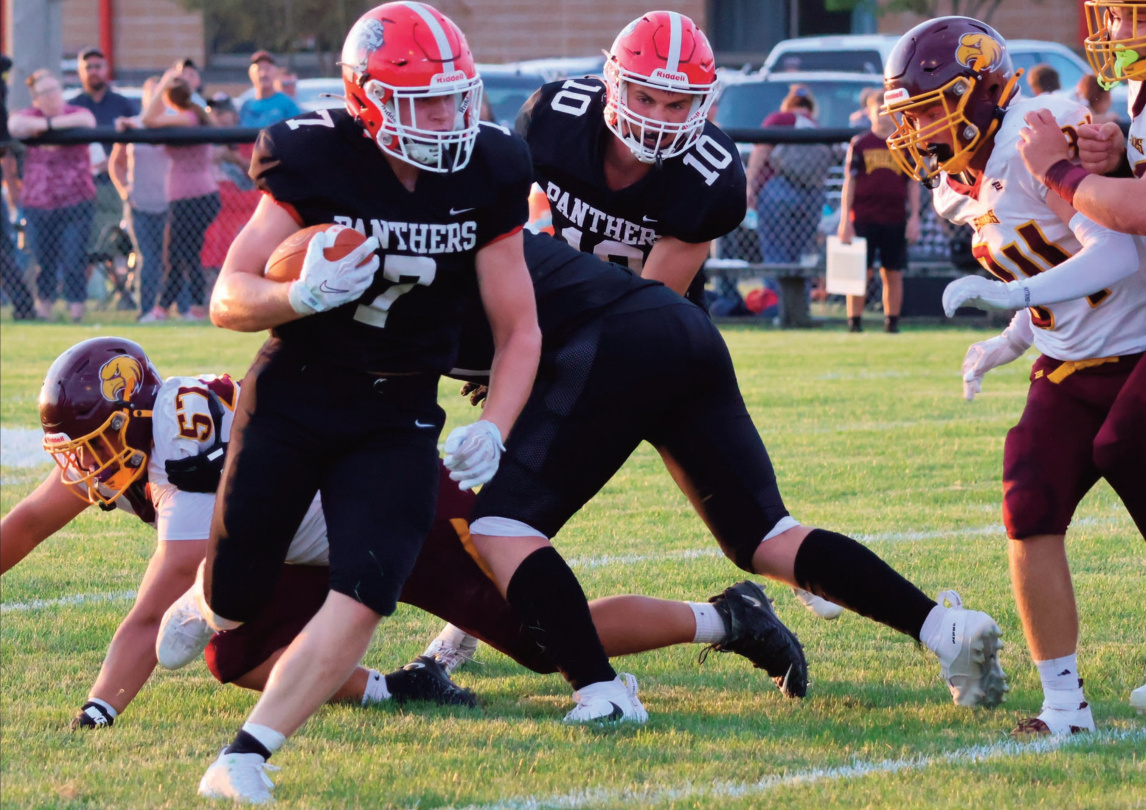 I-G's Cole Schauff cuts around end behind a block with Owen Wyatt (10) following the play. Photo by David Friesen.