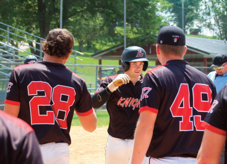 Knights celebrate at home plate after a home run