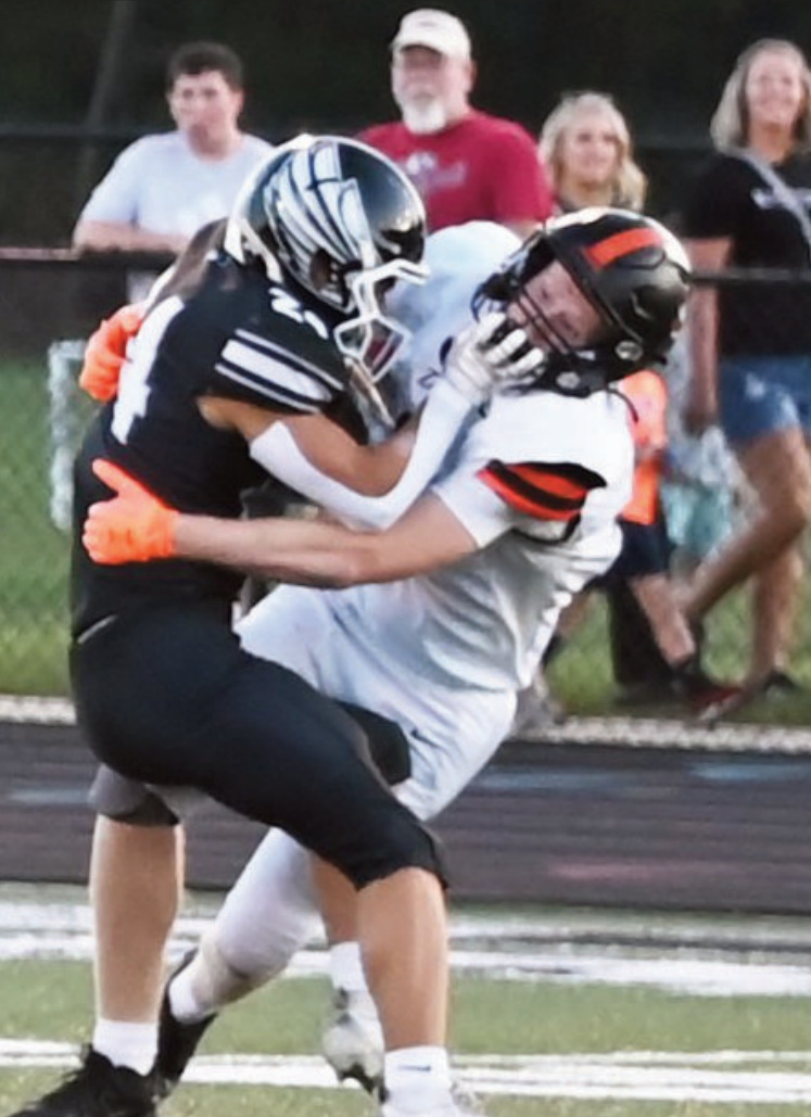 Dodgers Blake Stodola brings down Blackhawk Max Giroux. Photo by Heather Olson,