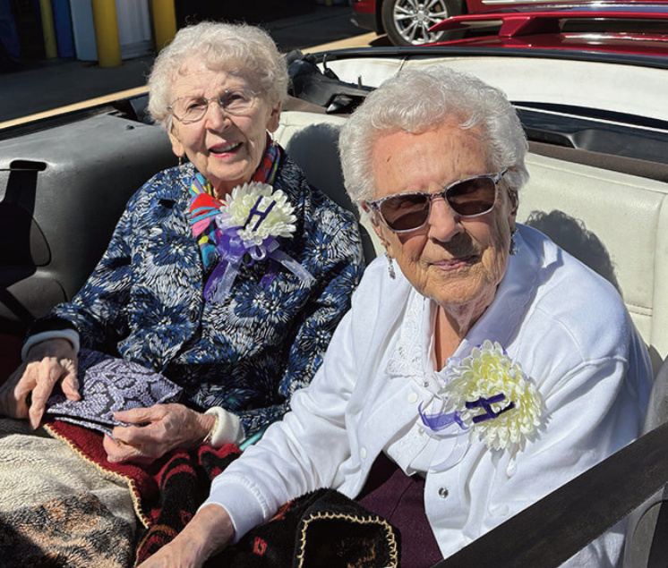 Helen (Gratton) Strand and Doris (Thompson) Kosloske ride through the Hol- landale Homecoming parade two years ago at age 100.