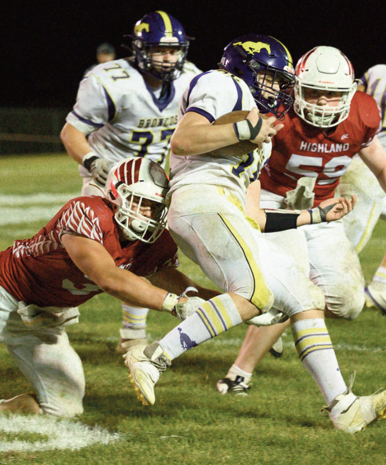 Tanner Degeghardt tries to wrap up an Orangeville player as Samuel Biba (59) moves in to help. Jonelle Degenhardt photo.