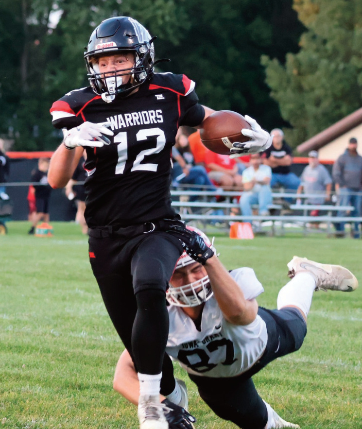 Panther Lane Foley tries to outrun a tackler. Photo by David Friesen.