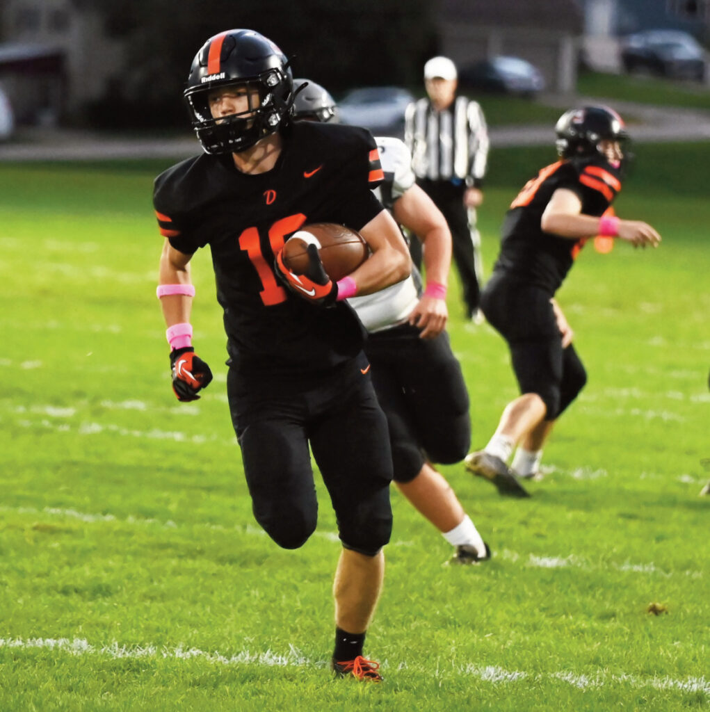 Dodger Braxton Staver finds an opening and uses his speed to return this kick-off for a touchdown. Heather Olson photo.