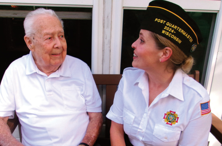 Norman Johnson, a World War II veteran, chats with Mandie Eagan, quartermaster for the Mineral Point VFW.