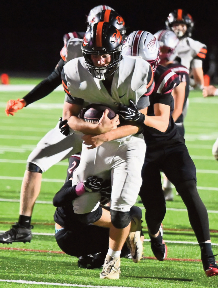 Dodger Finley Olson carries a Platteville tackler on this gain. Photo by Heather Olson.