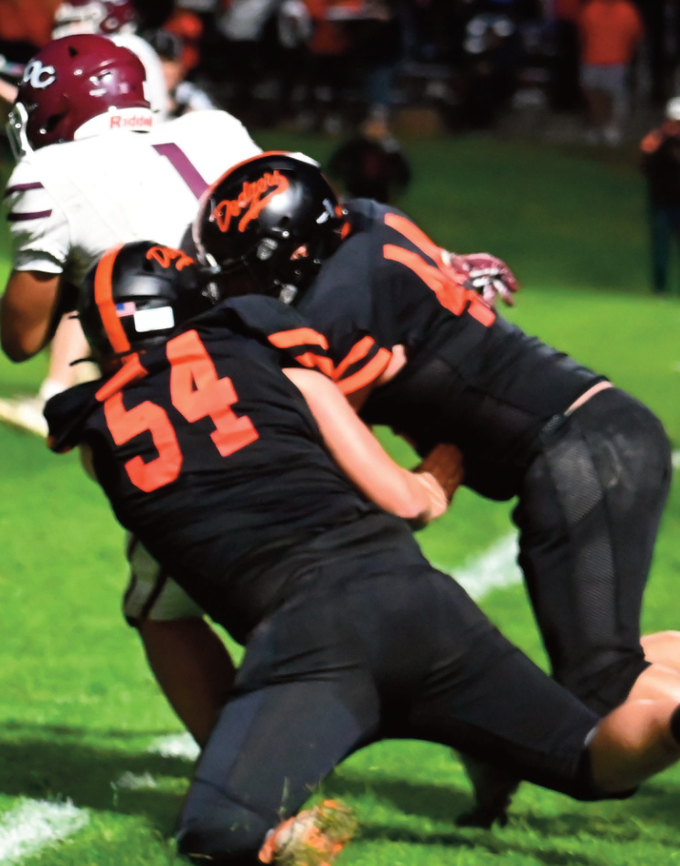 Briggs Hutson (54) and Elliot Jorenby bring down a ball carrier. Heather Olson photo.