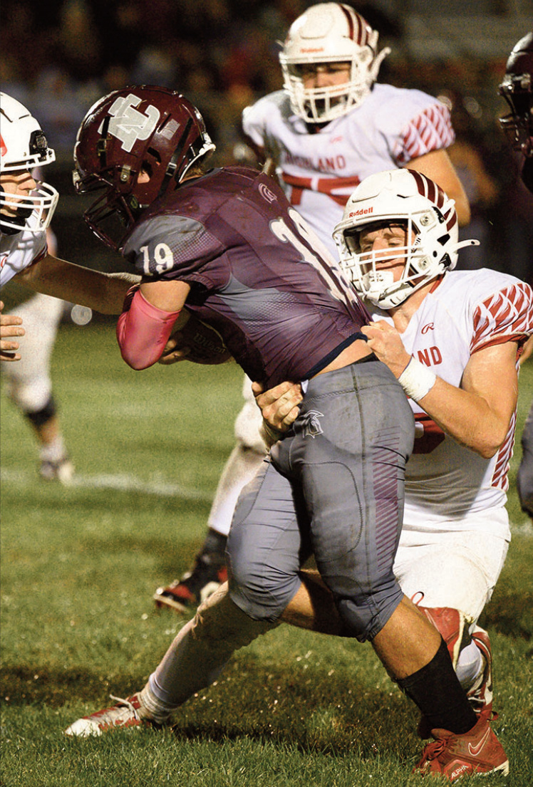Brady Nankey brings down a Trojans ball carrier. Jonelle Degenhardt photo.