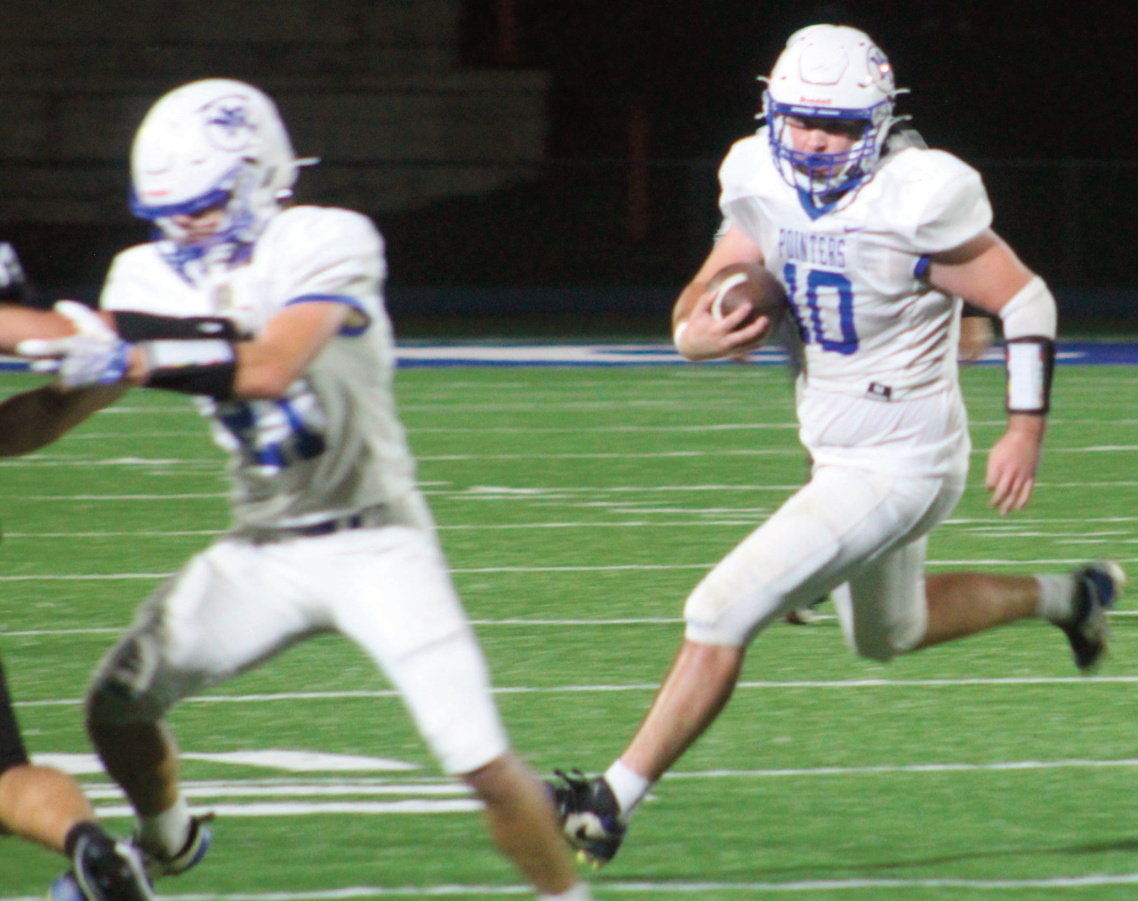 Clayton Yanna (10) turns up the field as Elliot Kite blocks for him.
